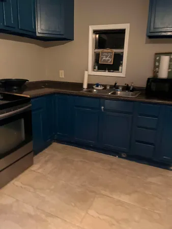 a living room with a couch and a stove next to a window