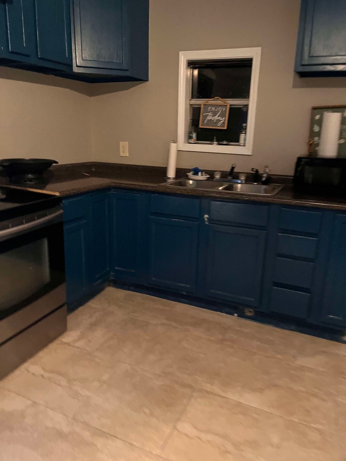 695 Grimes Avenue Silsbee, TX 77656 - Photo 19 of 29 a kitchen with wooden cabinets and a stove top oven