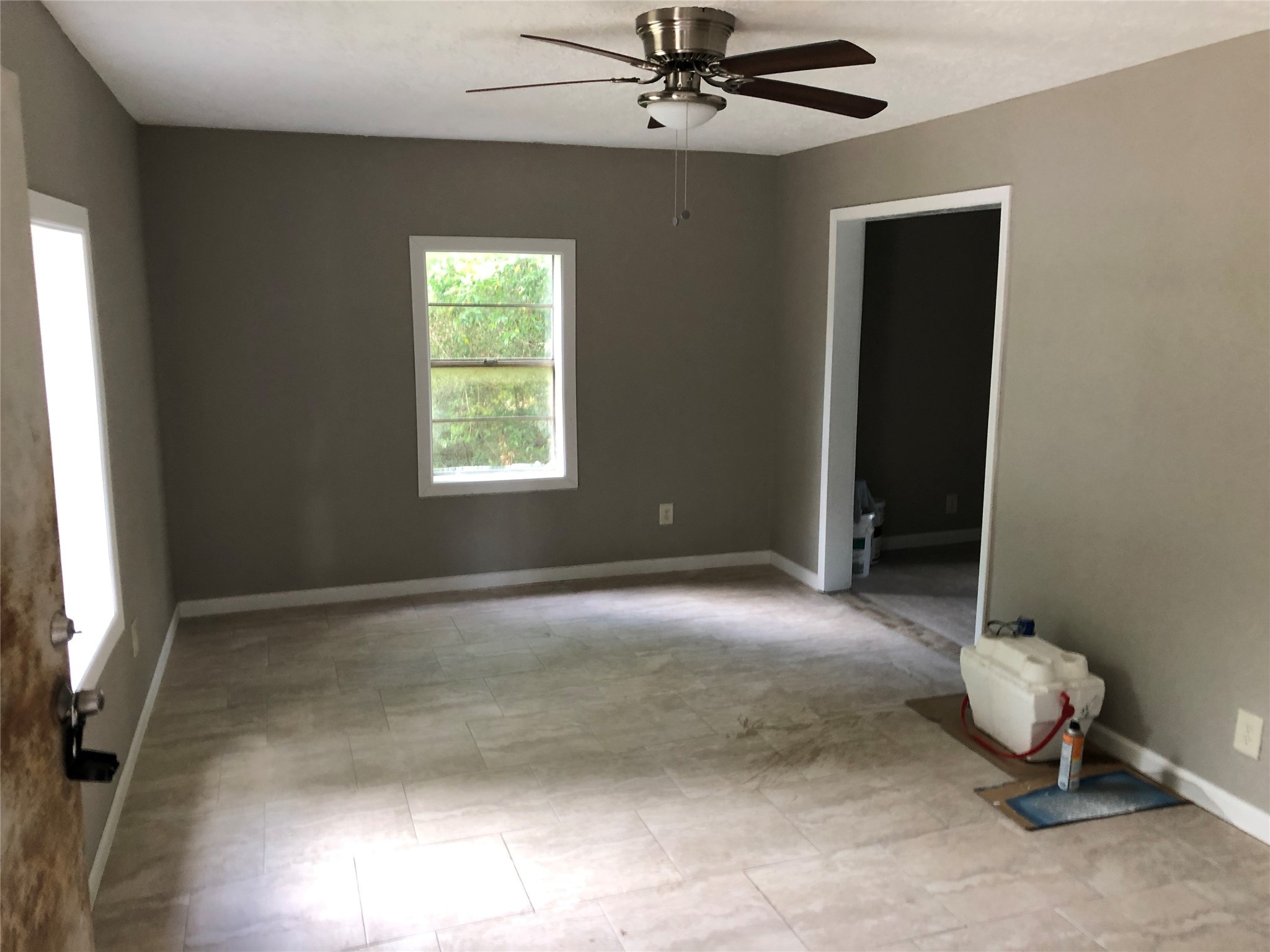 695 Grimes Avenue Silsbee, TX 77656 - Photo 24 of 29 a view of an empty room with window and chandelier fan