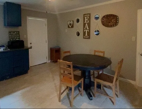 a view of a room that has a table and a chair in it
