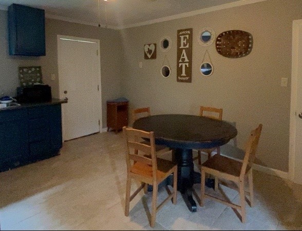 695 Grimes Avenue Silsbee, TX 77656 - Photo 10 of 29 a view of a room that has a table and a chair in it