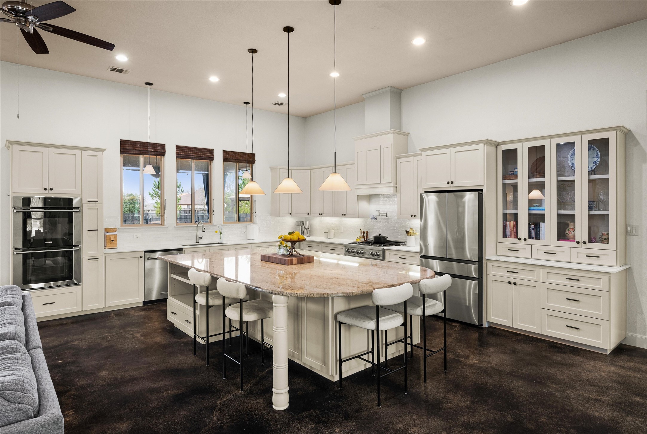 106 Fallow Way Bastrop, TX 78602 - Photo 2 of 40 Kitchen featuring a huge island with breakfast bar area, stainless steel appliances and custom built-in display cabinet