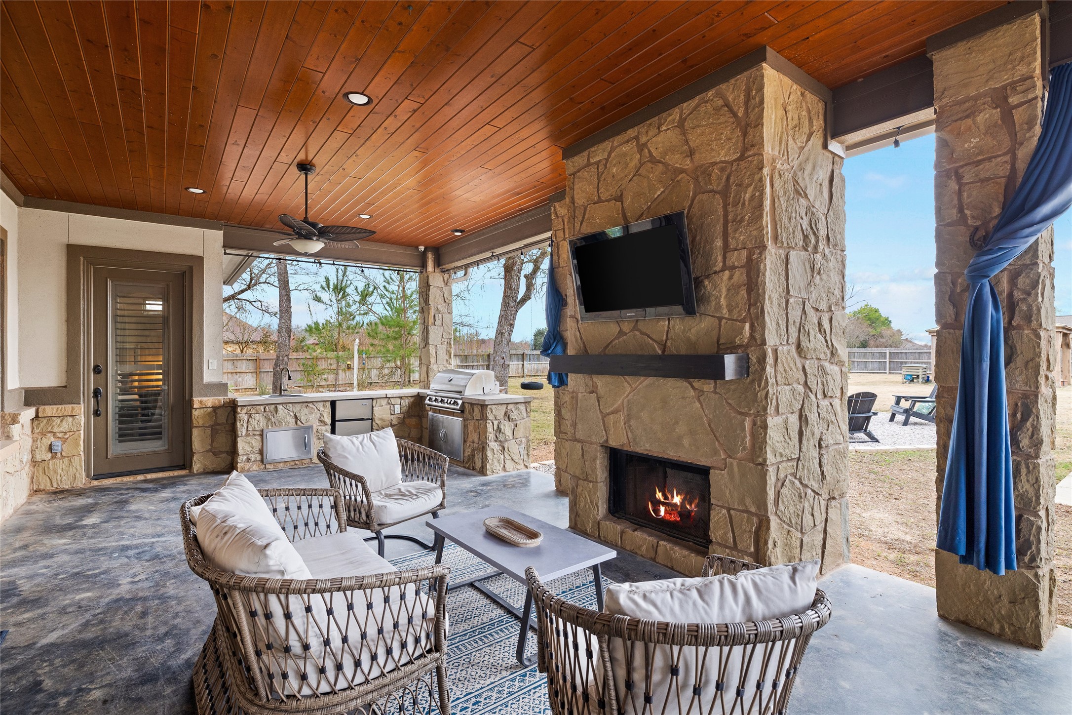 106 Fallow Way Bastrop, TX 78602 - Photo 31 of 40 Back patio with outdoor stone fireplace & outdoor kitchen