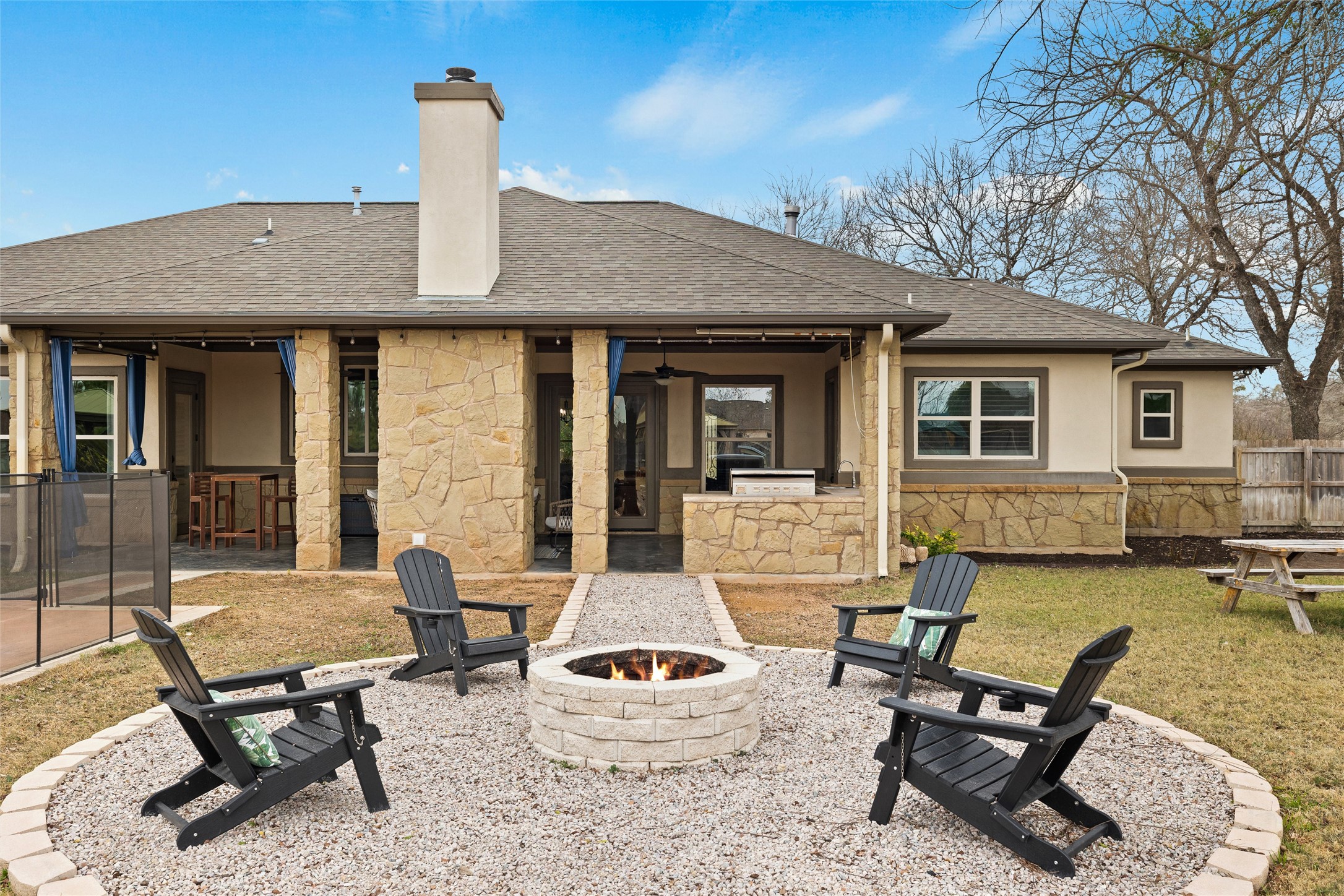 106 Fallow Way Bastrop, TX 78602 - Photo 33 of 40 Rear view of house from the outdoor firepit area