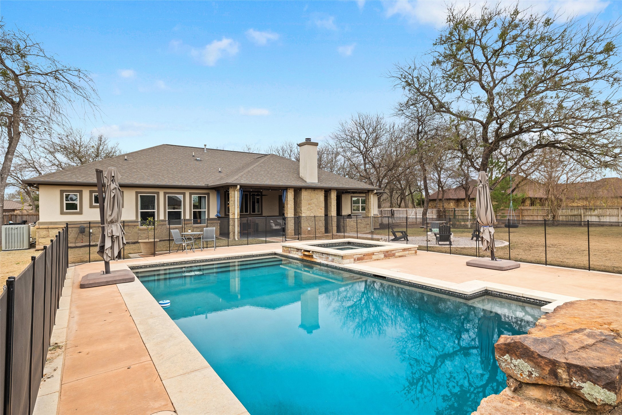 106 Fallow Way Bastrop, TX 78602 - Photo 35 of 40 Beautiful outdoor pool with attached spa, removable kid fence and plenty of decking around