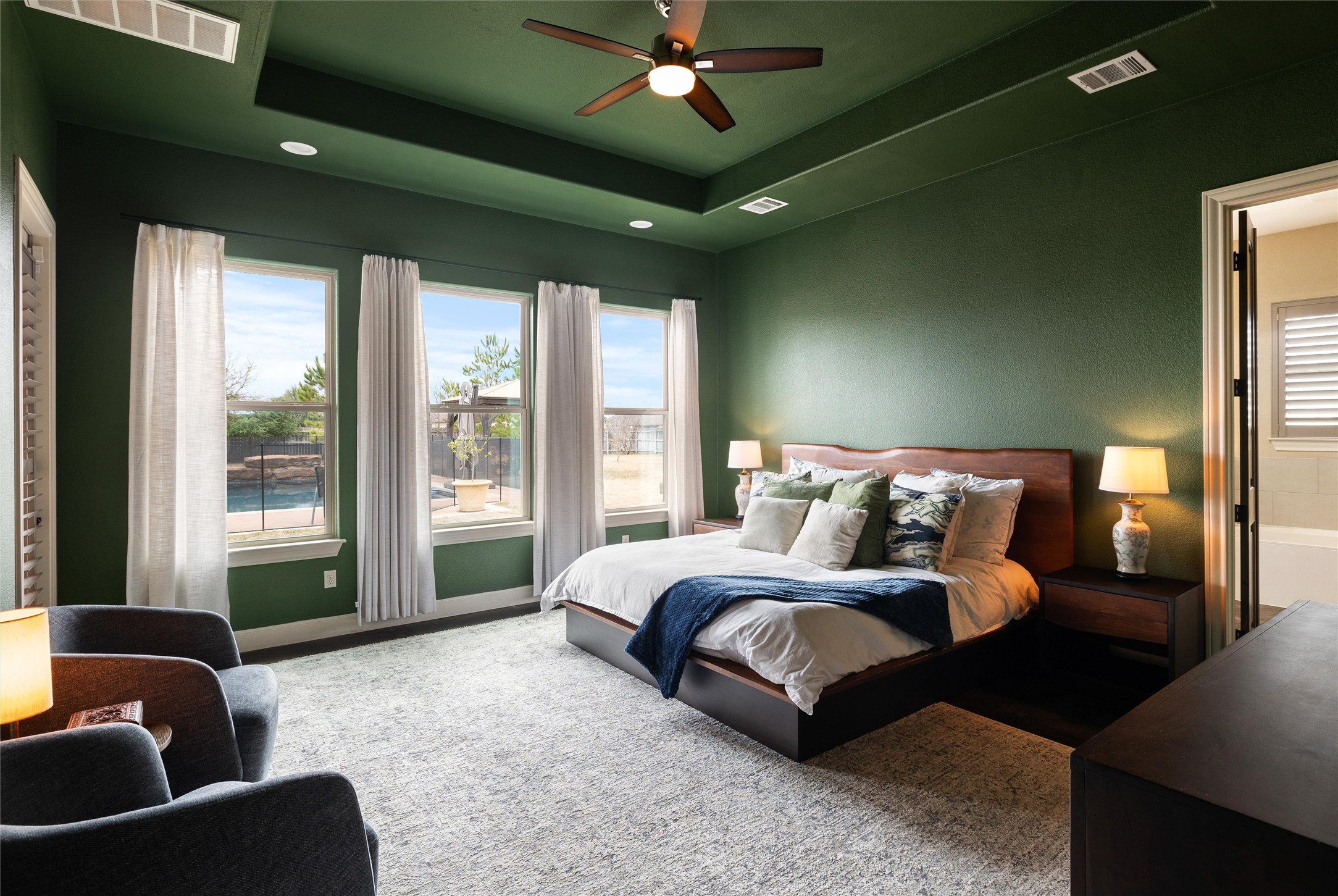 106 Fallow Way Bastrop, TX 78602 - Photo 4 of 40 Primary bedroom with large windows overlooking the backyard