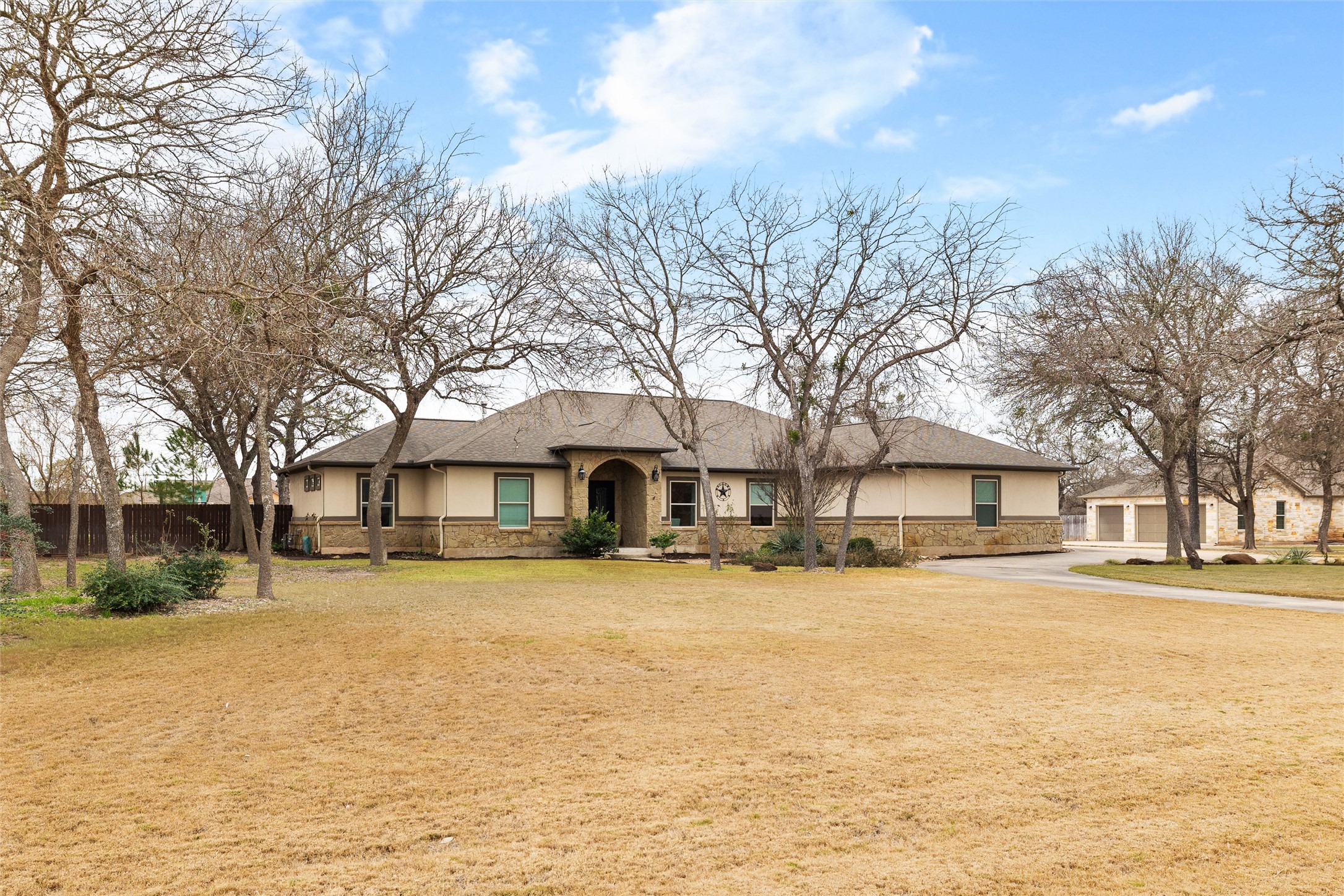106 Fallow Way Bastrop, TX 78602 - Photo 5 of 40 Ranch-style home with large front yard with plenty of large trees