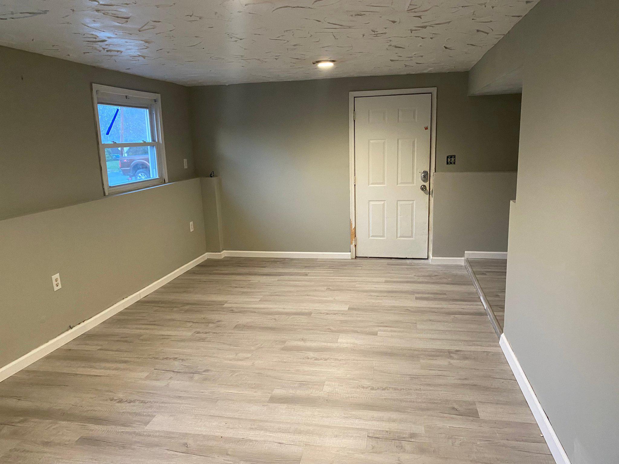 106 Parkview Road Stratford, NJ 08084 - Photo 16 of 27 an empty room with wooden floor and windows