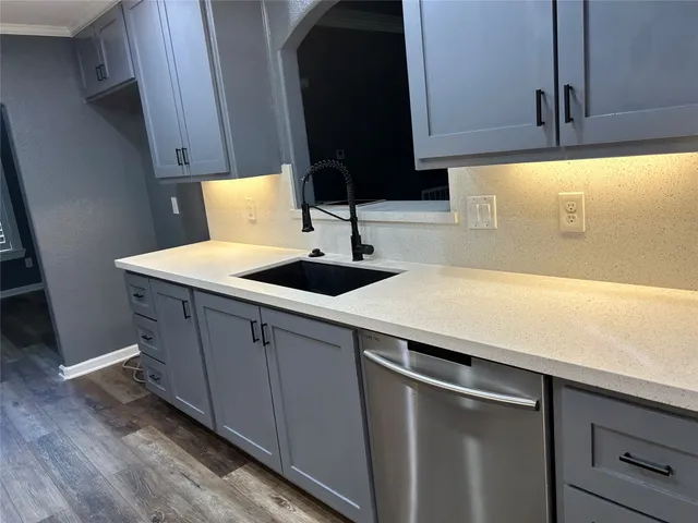 a kitchen with a sink and cabinets