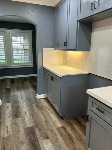 a view of an empty room with closet and a window