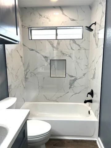 a bathroom with a sink a toilet and a bathtub