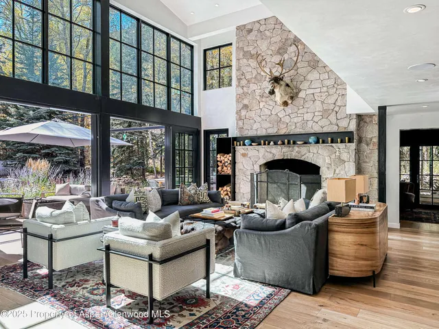 a living room with furniture fireplace and window