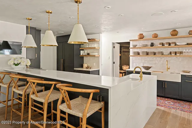 a bedroom with a bed a flat screen tv and a fireplace