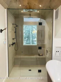 a room with wooden floor and a fireplace