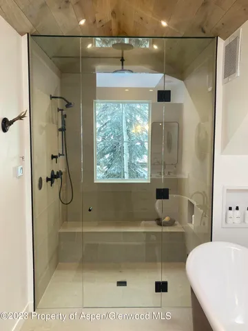 a room with wooden floor and a fireplace