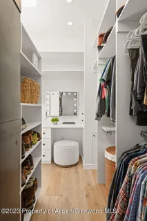 a bedroom with a bed two painting on the wall and a window