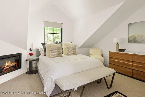 a view of a patio with couches chairs and a floor to ceiling window next to a yard