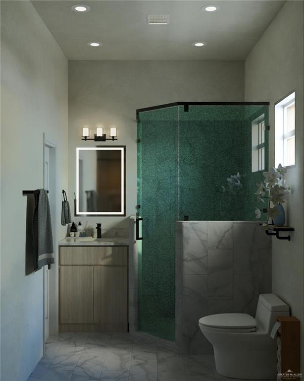 2909 Santa Amanda, Unit 1 Weslaco, TX 78596 - Photo 8 of 10 a bathroom with a toilet sink a mirror and glass door