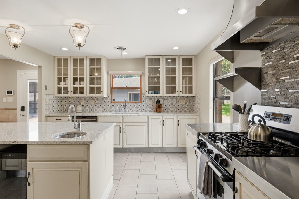 12135 Fitzhugh Road Austin, TX 78736 - Photo 2 of 30 a kitchen with stainless steel appliances granite countertop a stove and a sink
