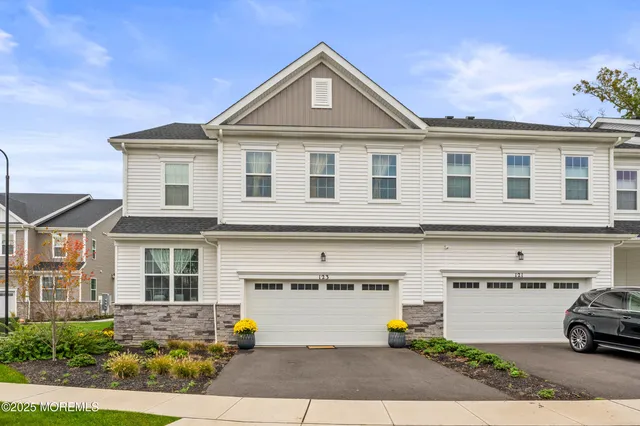 a front view of a house with a parking space