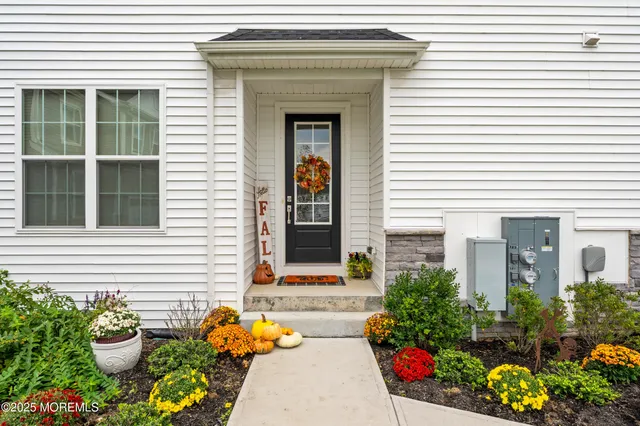 a front view of a house with outdoor seating
