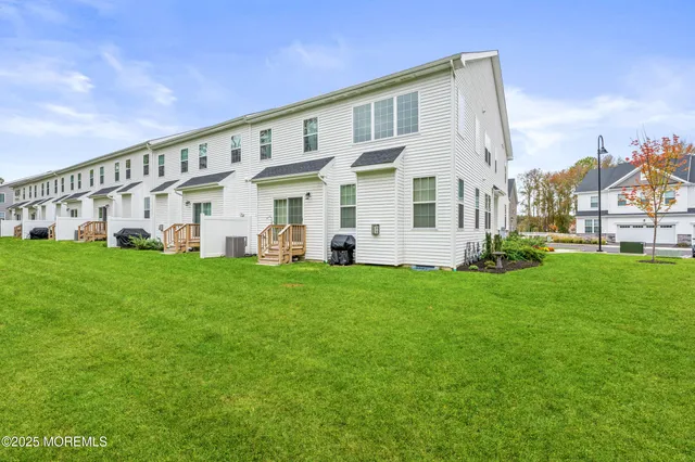 a front view of a house with a garden and plants