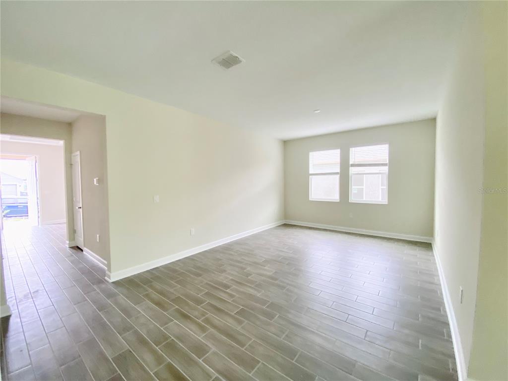 2768 Norway Maple Court Ocoee, FL 34761 - Photo 2 of 35 an empty room with wooden floor and windows