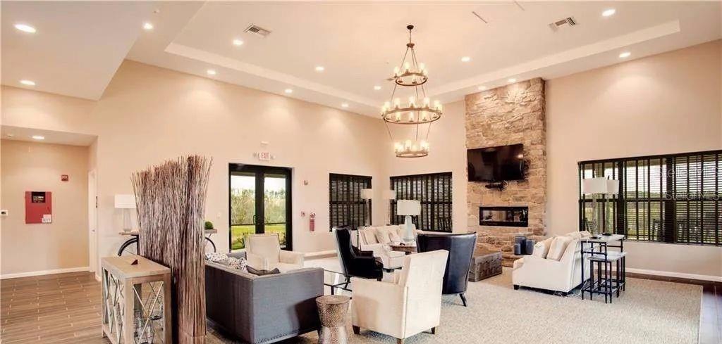 2768 Norway Maple Court Ocoee, FL 34761 - Photo 28 of 35 a living room with furniture a flat screen tv and a large window