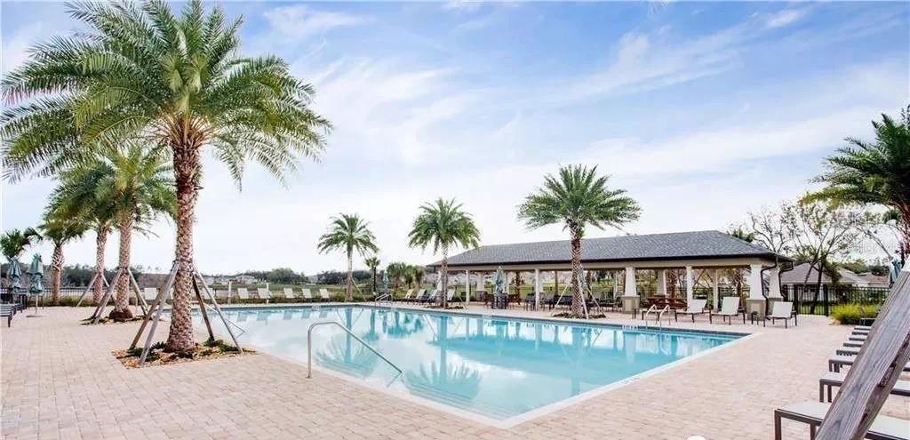 2768 Norway Maple Court Ocoee, FL 34761 - Photo 30 of 35 a view of a swimming pool with a table and chairs