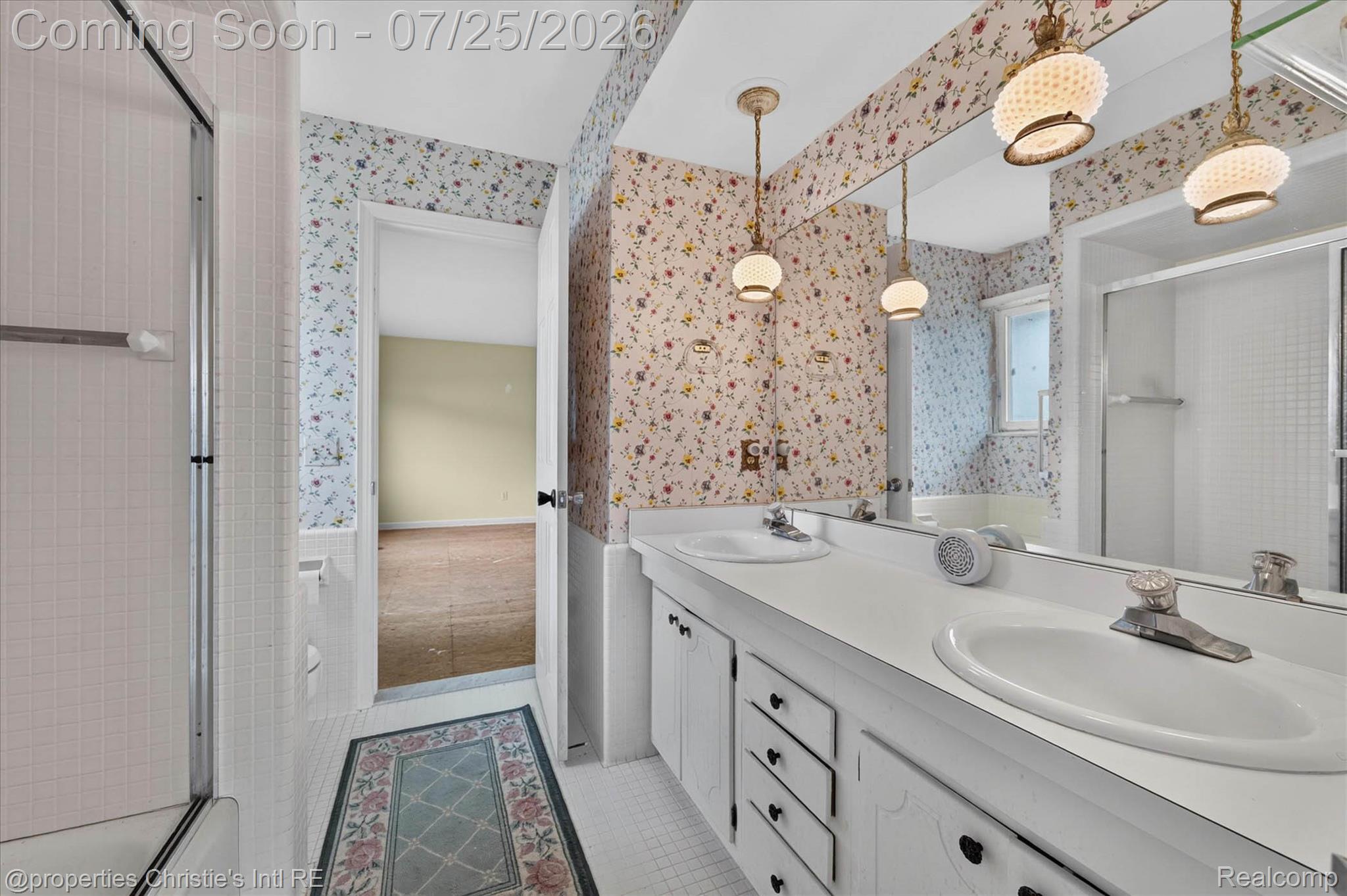 7292 Bluebill Road Algonac, MI 48001 - Photo 11 of 12 Bathroom featuring a double vanity with integrated sinks, a full-width mirror, and two decorative pendant lights