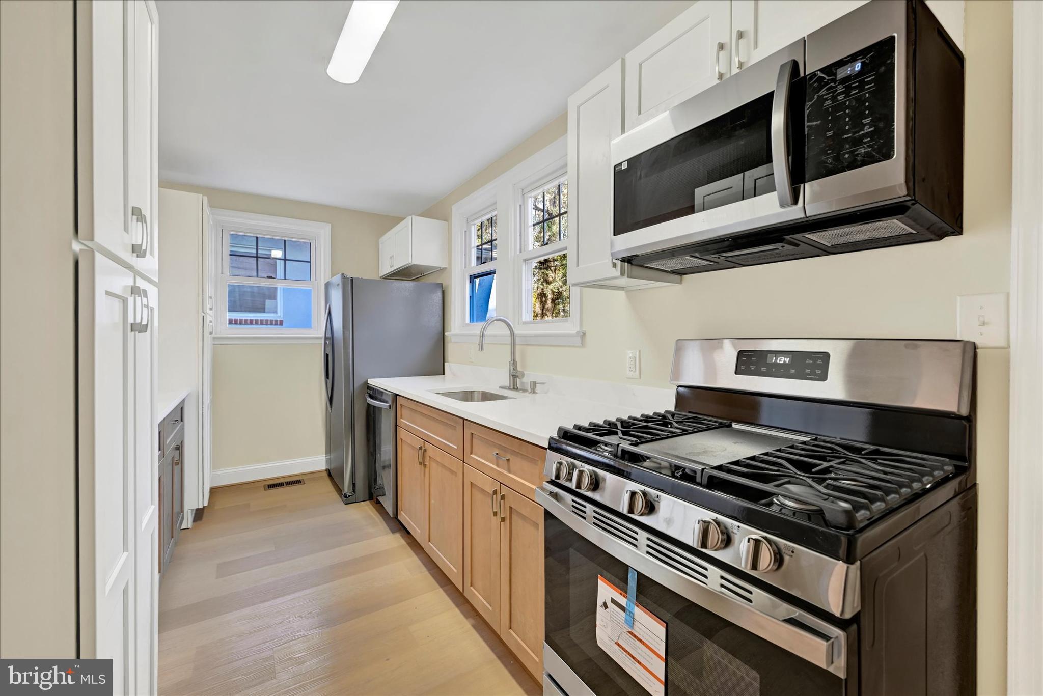 19 Dunmore Road Catonsville, MD 21228 - Photo 16 of 50 a kitchen with stainless steel appliances granite countertop a stove and a microwave