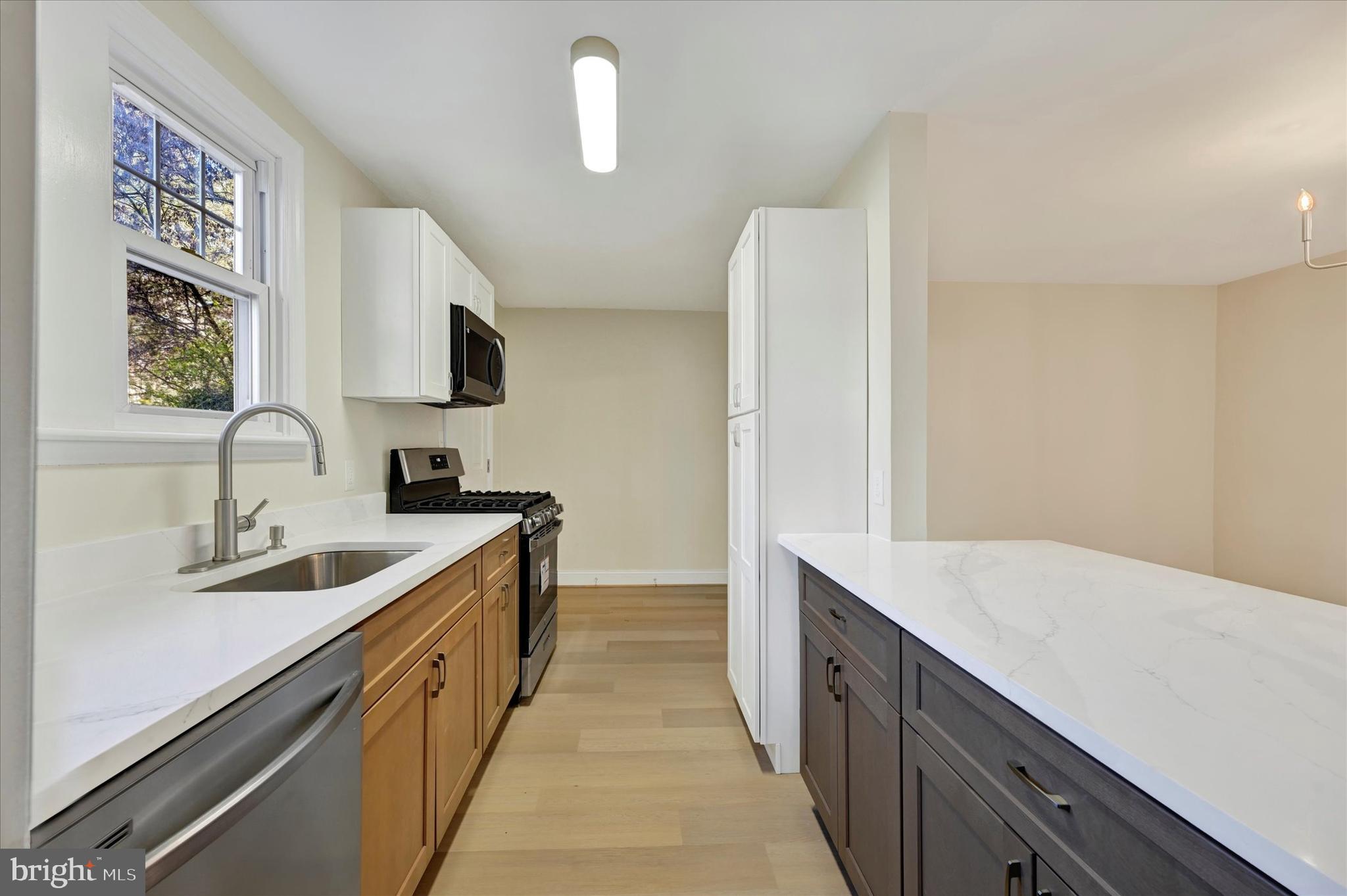 19 Dunmore Road Catonsville, MD 21228 - Photo 18 of 50 a kitchen with a sink and a refrigerator
