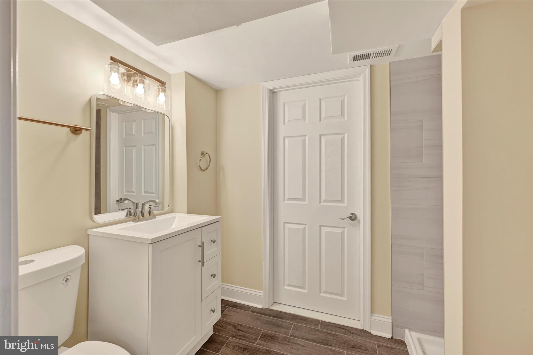 19 Dunmore Road Catonsville, MD 21228 - Photo 41 of 50 a bathroom with a sink a toilet and a mirror