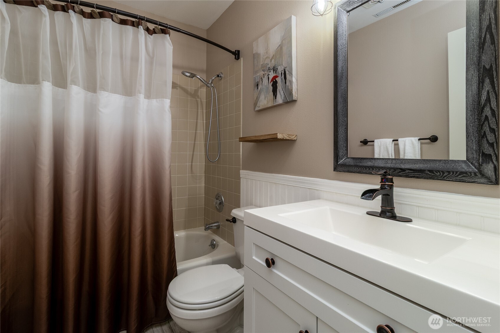 47 Austin Street Walla Walla, WA 99362 - Photo 22 of 40 a bathroom with a sink a toilet a mirror and shower curtain