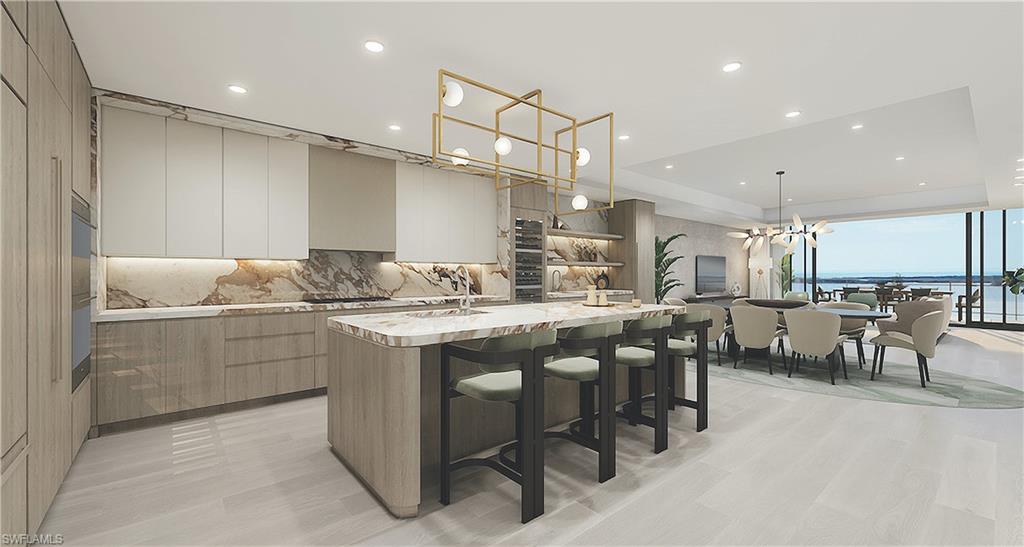 5000 Coconut Road, Unit 303 Bonita Springs, FL 34134 - Photo 18 of 27 a kitchen with center island table and chairs