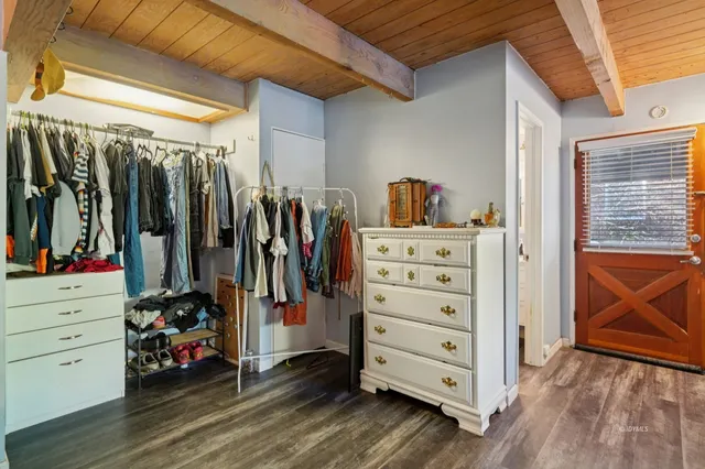 a view of walk in closet with clothes and shoes