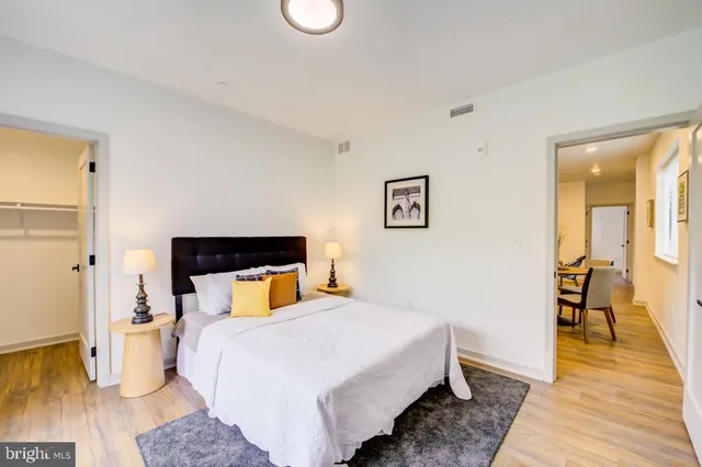 a bedroom with a bed and wooden floor