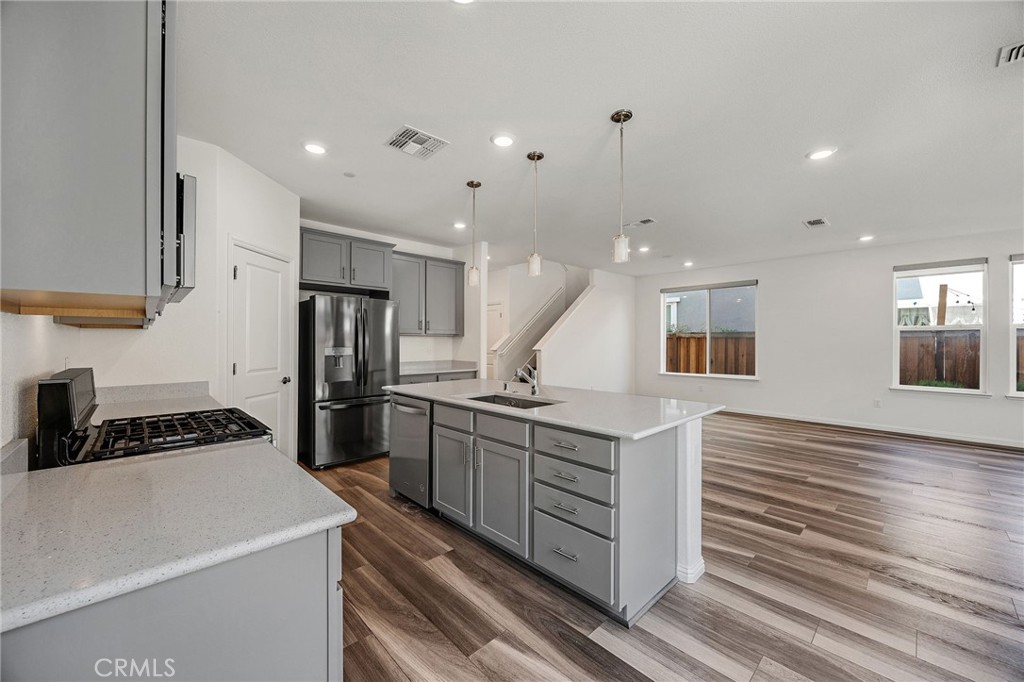 237 Goose Creek Avenue Brentwood, CA 94513 - Photo 11 of 49 a kitchen with a sink stainless steel appliances and cabinets