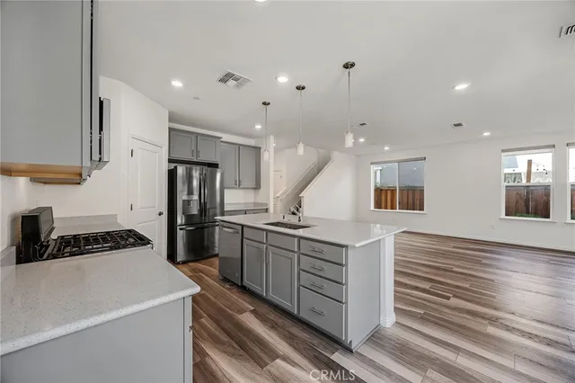a kitchen with a sink stainless steel appliances and cabinets