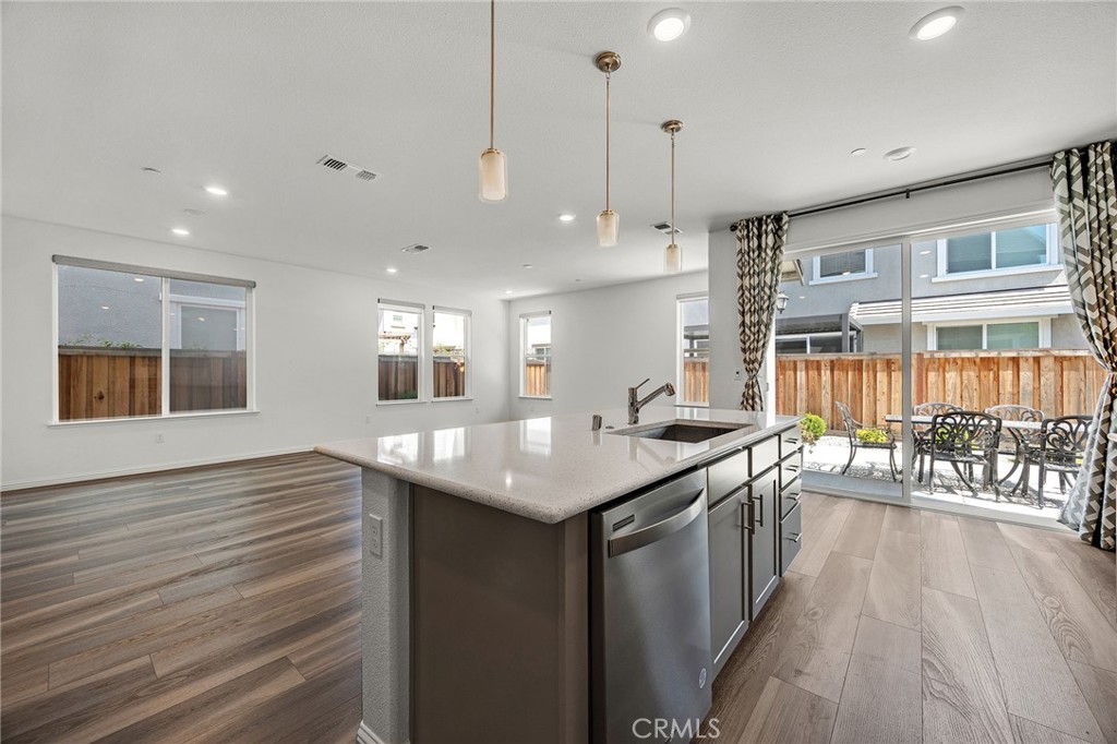 237 Goose Creek Avenue Brentwood, CA 94513 - Photo 12 of 49 a kitchen with stainless steel appliances granite countertop a kitchen island a stove and a wooden floors