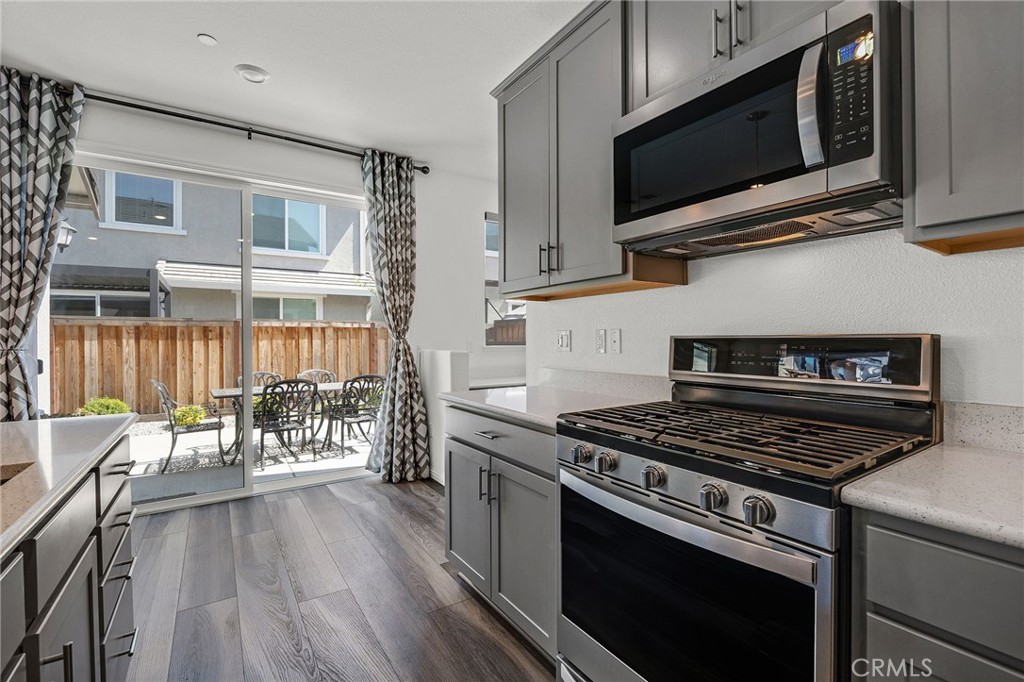 237 Goose Creek Avenue Brentwood, CA 94513 - Photo 13 of 49 a kitchen with stainless steel appliances a white cabinet and a stove top oven