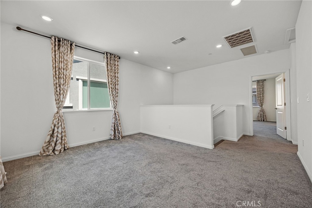 237 Goose Creek Avenue Brentwood, CA 94513 - Photo 17 of 49 an empty room with windows and refrigerator