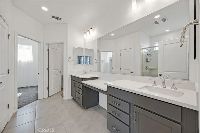 a spacious bathroom with a shower sink double and mirror