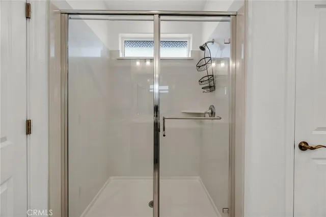 a bathroom with a glass shower door