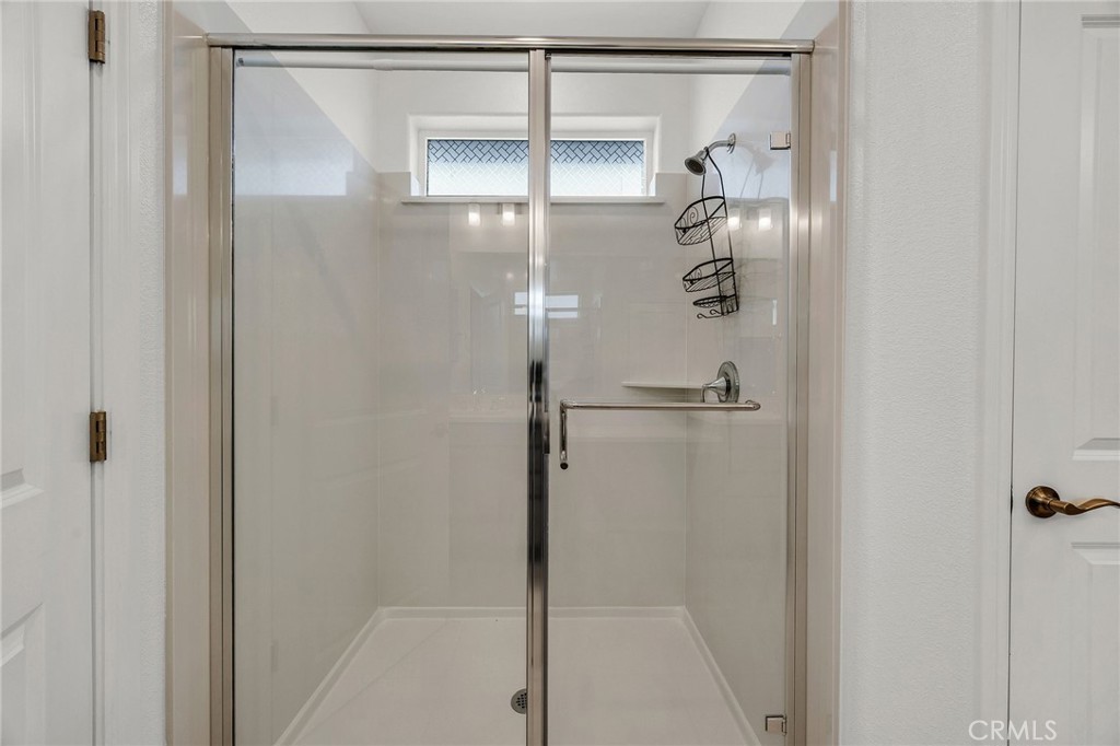 237 Goose Creek Avenue Brentwood, CA 94513 - Photo 24 of 49 a bathroom with a glass shower door