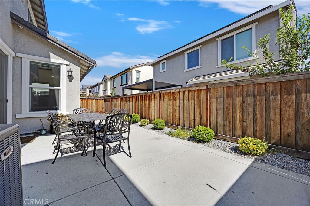 237 Goose Creek Avenue Brentwood, CA 94513 - Photo 39 of 49 a patio with table and chairs and potted plants