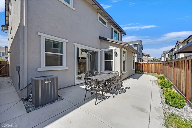 a view of a house with backyard and sitting area