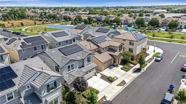 an aerial view of a house with a swimming pool yard and outdoor seating