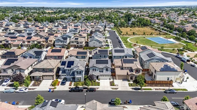 an aerial view of residential houses with outdoor space