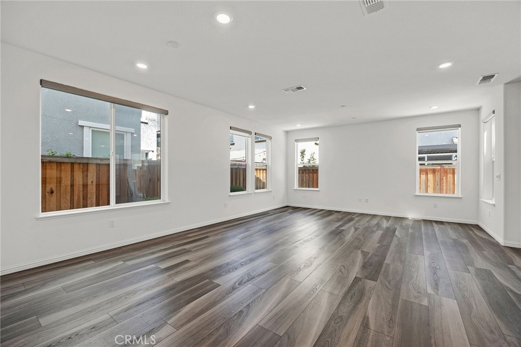 237 Goose Creek Avenue Brentwood, CA 94513 - Photo 7 of 49 a view of an empty room with wooden floor and a window